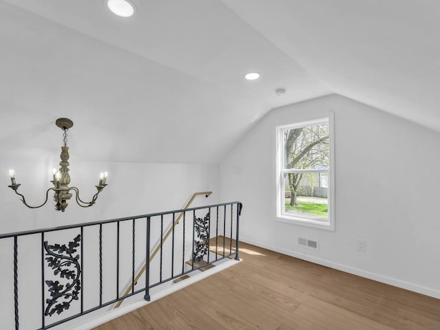 4208 Locust St, Delavan, WI 53115 - additional living space with a chandelier, wood finished floors, lofted ceiling, baseboards, and recessed lighting