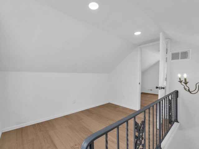 4208 Locust St, Delavan, WI 53115 - bonus room with lofted ceiling, wood finished floors, baseboards, and recessed lighting