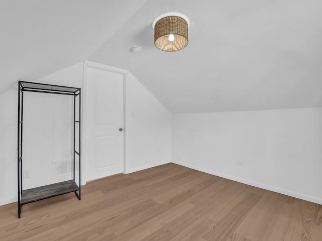 4208 Locust St, Delavan, WI 53115 - bonus room featuring wood finished floors, vaulted ceiling, and baseboards