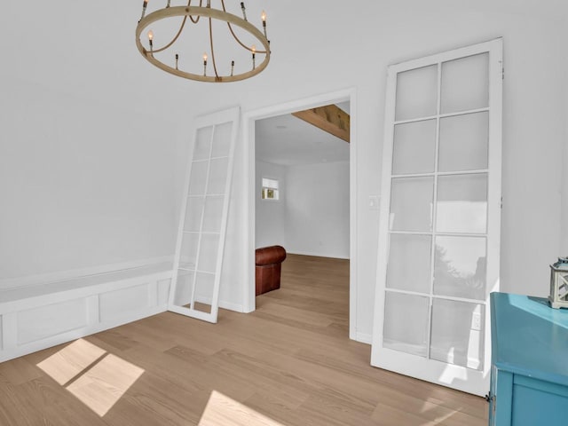 4208 Locust St, Delavan, WI 53115 - unfurnished dining area featuring a chandelier, wood finished floors, and wainscoting