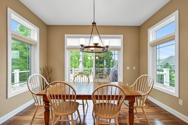 W229N3637 Sterling Ct, Pewaukee, WI 53072 - dining area with plenty of natural light, dark wood-style flooring, and a chandelier