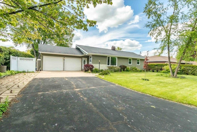 2931 N Ave, Wisconsin Rapids, WI 54495 - ranch-style home featuring a garage, asphalt driveway, and a chimney