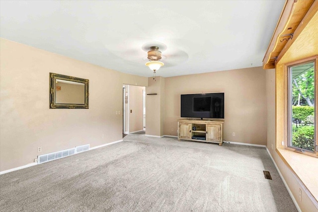 2931 N Ave, Wisconsin Rapids, WI 54495 - unfurnished living room with carpet floors, a ceiling fan, and baseboards