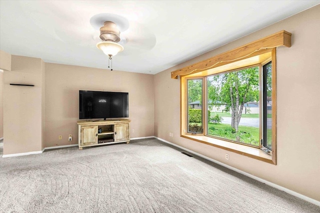2931 N Ave, Wisconsin Rapids, WI 54495 - unfurnished living room with carpet flooring, baseboards, and a ceiling fan