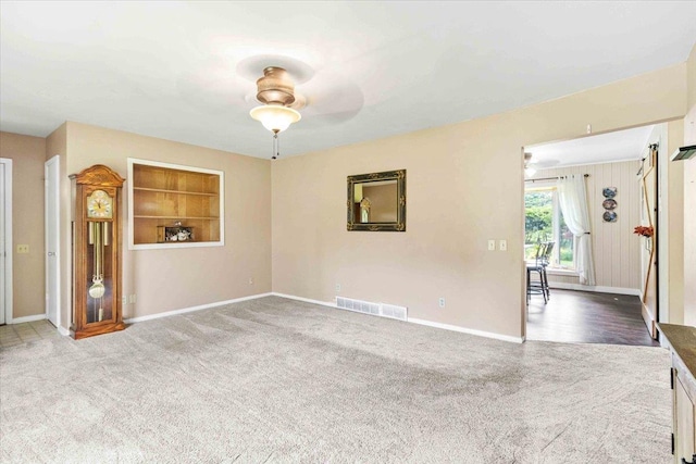 2931 N Ave, Wisconsin Rapids, WI 54495 - unfurnished living room with carpet floors, a ceiling fan, and baseboards
