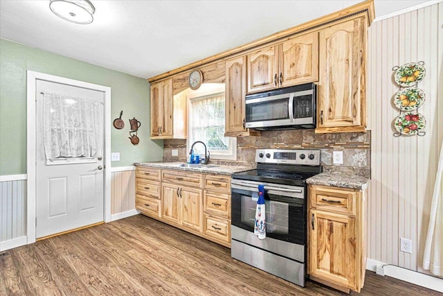 2931 N Ave, Wisconsin Rapids, WI 54495 - kitchen featuring stainless steel appliances, a sink, dark wood-type flooring, light brown cabinets, and a wainscoted wall