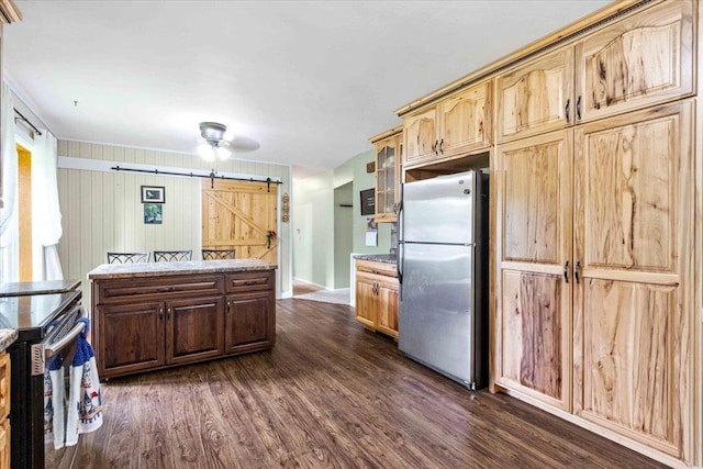 2931 N Ave, Wisconsin Rapids, WI 54495 - kitchen with appliances with stainless steel finishes, a barn door, dark wood-style floors, glass insert cabinets, and light stone counters