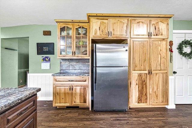 2931 N Ave, Wisconsin Rapids, WI 54495 - kitchen featuring freestanding refrigerator, glass insert cabinets, dark wood-type flooring, lofted ceiling, and dark stone countertops