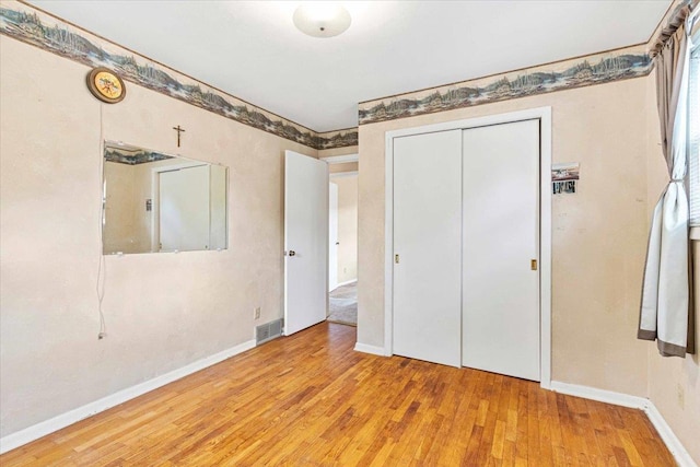 2931 N Ave, Wisconsin Rapids, WI 54495 - unfurnished bedroom with wood finished floors, a closet, and baseboards