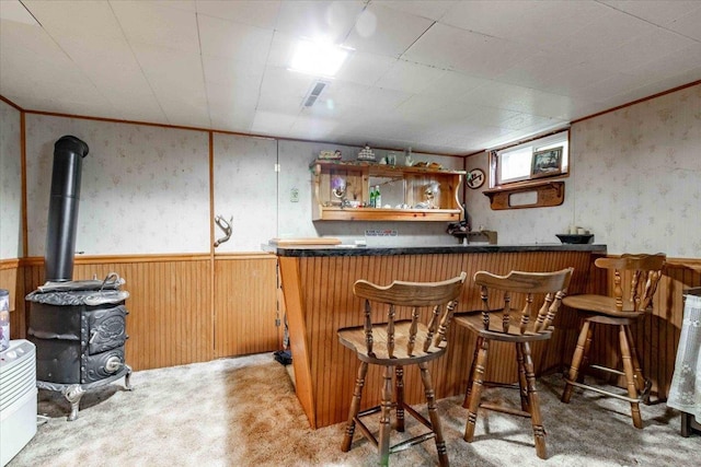 2931 N Ave, Wisconsin Rapids, WI 54495 - indoor dry bar featuring carpet flooring, wainscoting, wood walls, a wood stove, and wallpapered walls