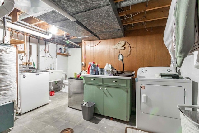 2931 N Ave, Wisconsin Rapids, WI 54495 - washroom with washer and clothes dryer, a sink, and wooden walls