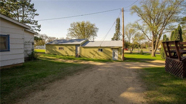 207 State Road 25, Wheeler, WI 54772 - view of grassy yard with dirt driveway and an outbuilding