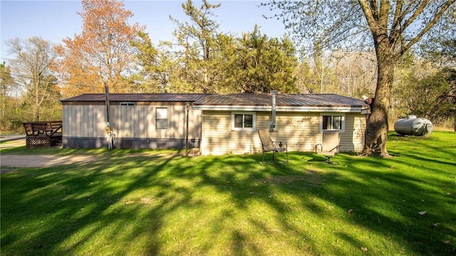 207 State Road 25, Wheeler, WI 54772 - view of home's exterior featuring a yard and metal roof