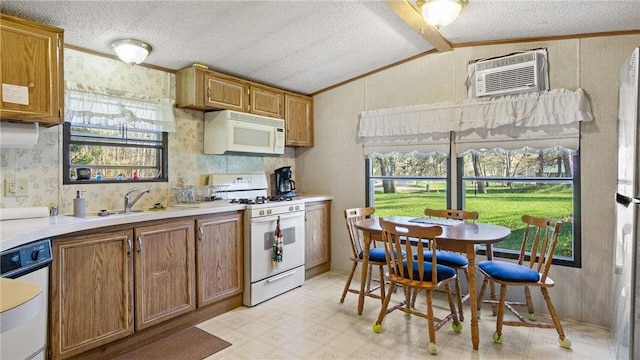 207 State Road 25, Wheeler, WI 54772 - kitchen featuring white appliances, vaulted ceiling, light floors, brown cabinets, and light countertops