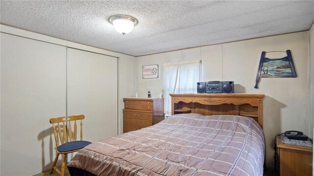 207 State Road 25, Wheeler, WI 54772 - bedroom with a textured ceiling and a closet
