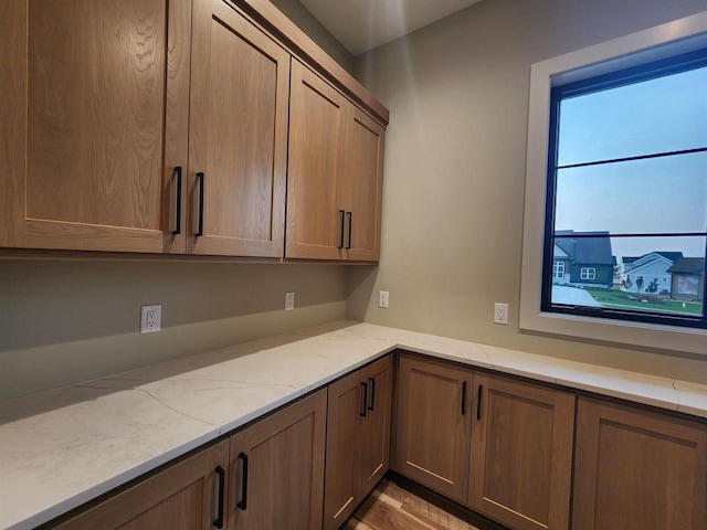 1102 Moll Dr, Waunakee, WI 53597 - kitchen with light stone counters and wood finished floors