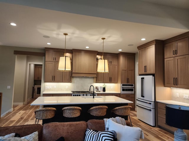 1102 Moll Dr, Waunakee, WI 53597 - kitchen with freestanding refrigerator, light countertops, tasteful backsplash, and recessed lighting