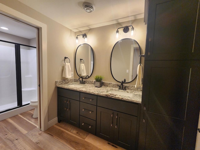 1102 Moll Dr, Waunakee, WI 53597 - full bathroom with wood finished floors, double vanity, and a shower stall