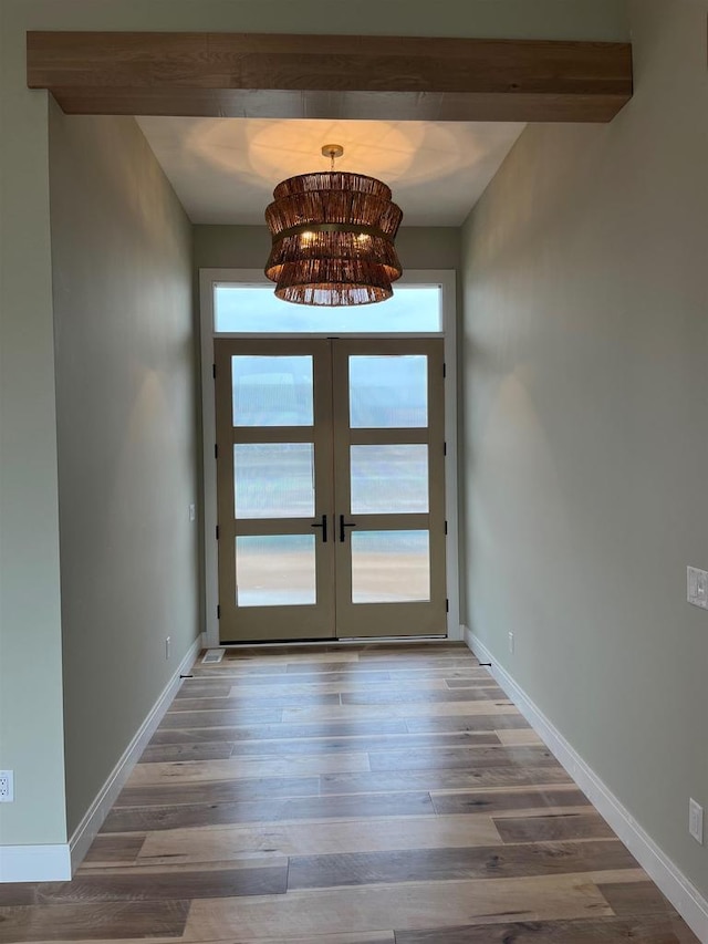 1102 Moll Dr, Waunakee, WI 53597 - doorway featuring healthy amount of natural light, french doors, wood finished floors, beam ceiling, and a chandelier