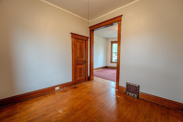 1401 N 2nd St, Wausau, WI 54403 - unfurnished room featuring baseboards, wood finished floors, and crown molding