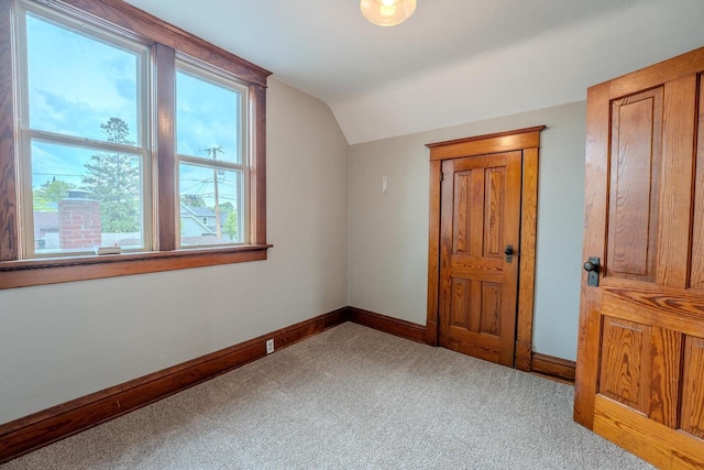 1401 N 2nd St, Wausau, WI 54403 - additional living space with vaulted ceiling, carpet flooring, and baseboards