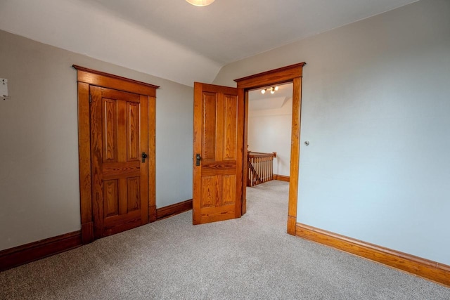 1401 N 2nd St, Wausau, WI 54403 - unfurnished bedroom featuring carpet flooring, lofted ceiling, and baseboards