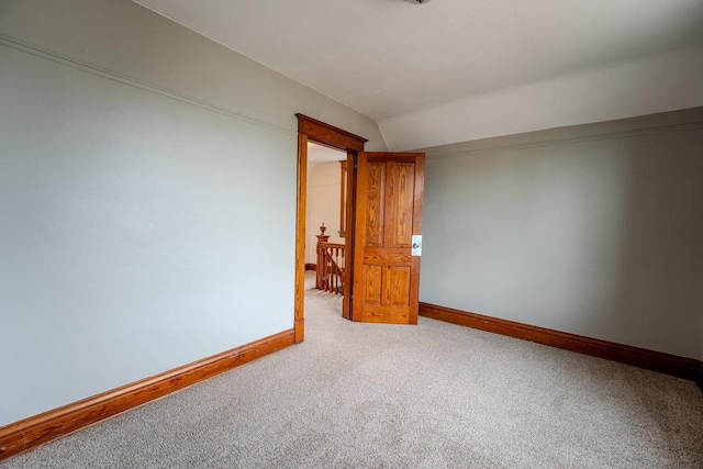 1401 N 2nd St, Wausau, WI 54403 - spare room featuring carpet floors, baseboards, and vaulted ceiling