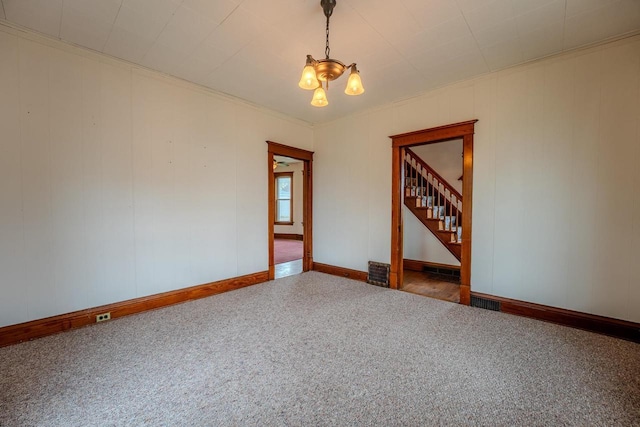 1401 N 2nd St, Wausau, WI 54403 - carpeted spare room featuring a chandelier, baseboards, stairway, and ornamental molding