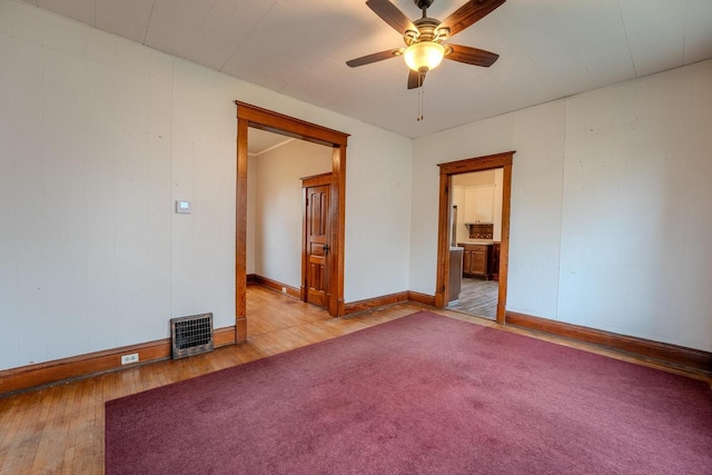 1401 N 2nd St, Wausau, WI 54403 - unfurnished room with wood-type flooring, baseboards, and ceiling fan