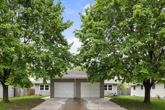 1208 Grove St, Menasha, WI 54952 - view of property hidden behind natural elements with concrete driveway, an attached garage, and roof with shingles