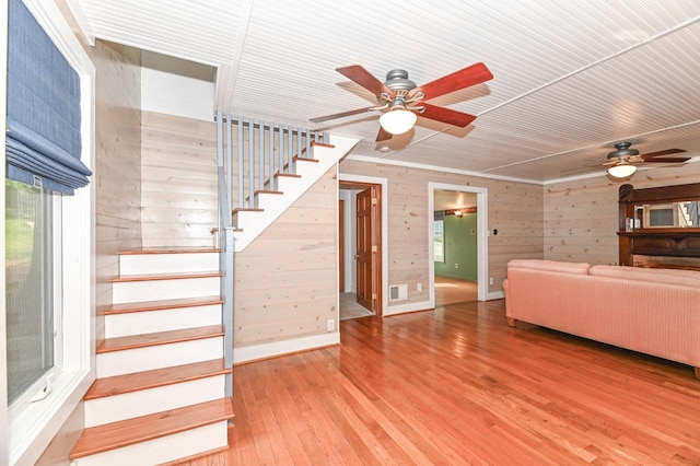 2811 Alpine Ln, Delavan, WI 53115 - living area featuring ceiling fan, stairway, wood walls, and light wood finished floors