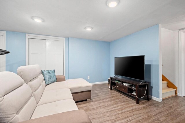 1346 Partridge Ct, Oshkosh, WI 54904 - living room with baseboards, light wood-style flooring, and stairs