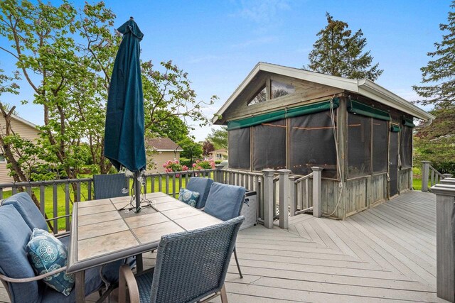 1346 Partridge Ct, Oshkosh, WI 54904 - wooden deck featuring outdoor dining area and a sunroom