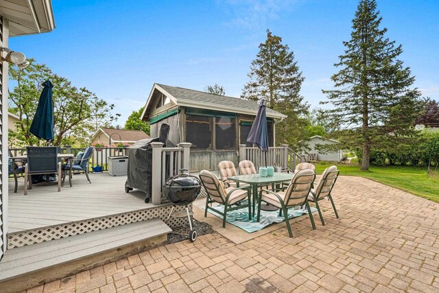 1346 Partridge Ct, Oshkosh, WI 54904 - view of patio featuring outdoor dining area, a sunroom, and a wooden deck