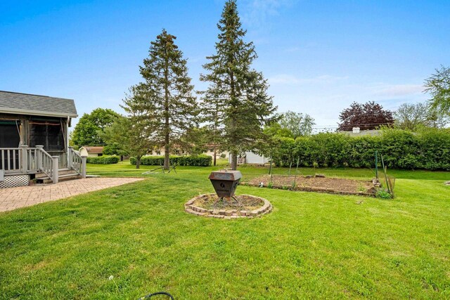 1346 Partridge Ct, Oshkosh, WI 54904 - view of green lawn featuring a sunroom and a patio