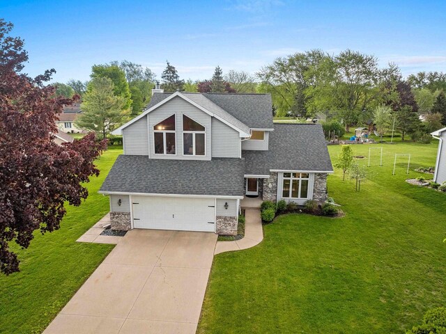 1346 Partridge Ct, Oshkosh, WI 54904 - view of front of property featuring stone siding, a garage, concrete driveway, and a front lawn