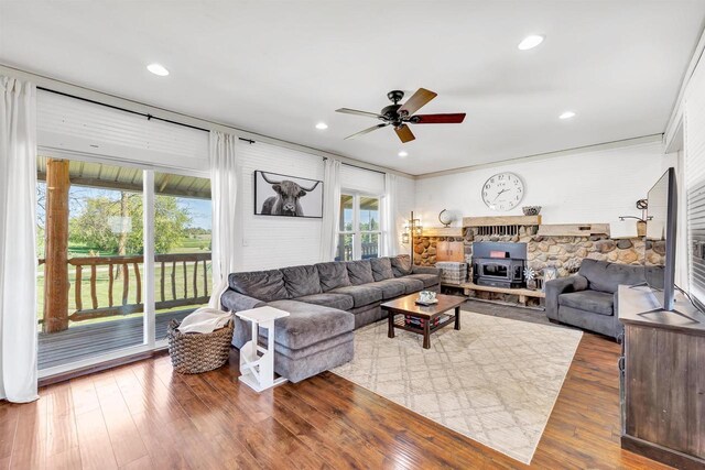 4600 Kamper Ln, Denmark, WI 54208 - living room featuring a wood stove, a ceiling fan, wood finished floors, and recessed lighting