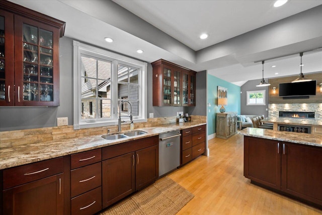 4320 High, Point Beach Lane, Port Washington, WI 53074 - kitchen featuring a sink, stainless steel dishwasher, light wood finished floors, open floor plan, and glass insert cabinets