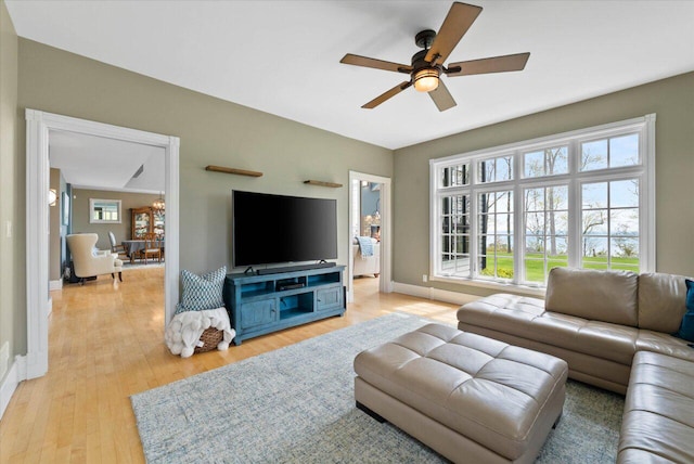 4320 High, Point Beach Lane, Port Washington, WI 53074 - living room featuring a ceiling fan, light wood finished floors, and baseboards