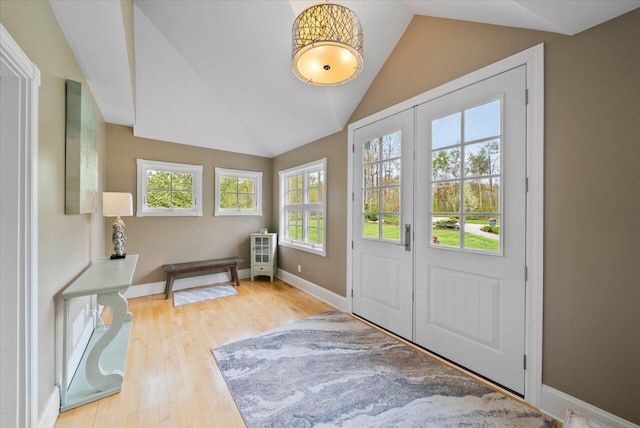4320 High, Point Beach Lane, Port Washington, WI 53074 - doorway featuring vaulted ceiling, wood finished floors, and baseboards