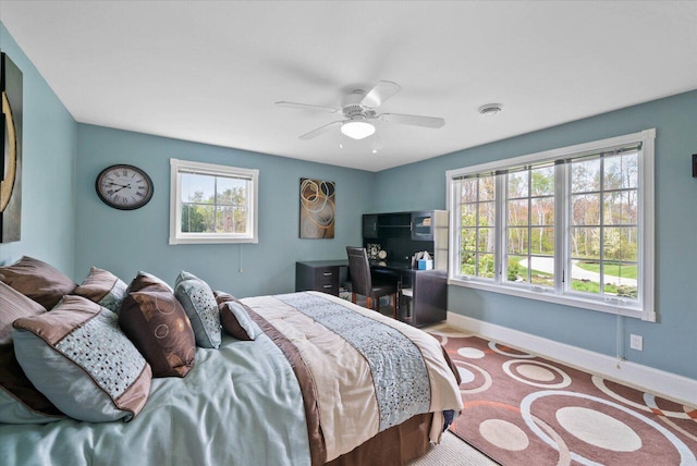 4320 High, Point Beach Lane, Port Washington, WI 53074 - carpeted bedroom with multiple windows, baseboards, and ceiling fan