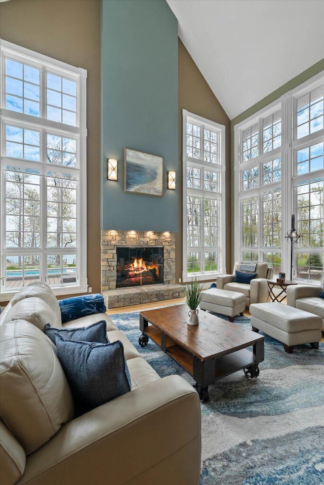 4320 High, Point Beach Lane, Port Washington, WI 53074 - living room featuring high vaulted ceiling, a stone fireplace, and plenty of natural light