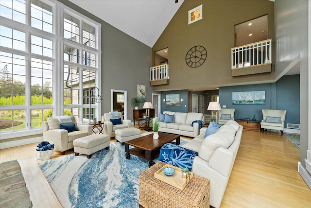 4320 High, Point Beach Lane, Port Washington, WI 53074 - living room with high vaulted ceiling, wood finished floors, and baseboards