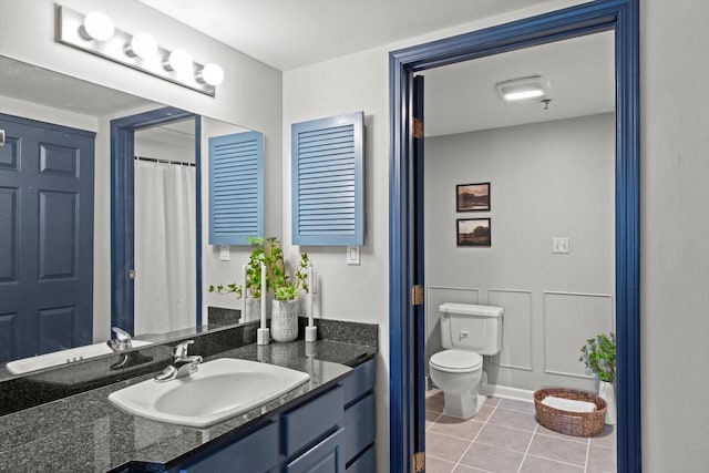 270 E Highland Ave Unit 1031, Milwaukee, WI 53202 - full bathroom featuring vanity, toilet, and tile patterned flooring
