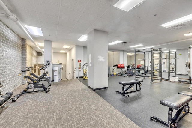 270 E Highland Ave Unit 1031, Milwaukee, WI 53202 - workout area with brick wall and a drop ceiling