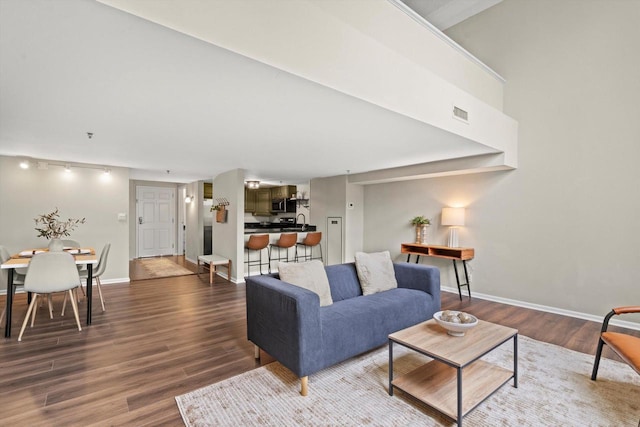 270 E Highland Ave Unit 1031, Milwaukee, WI 53202 - living area featuring wood finished floors, baseboards, and rail lighting