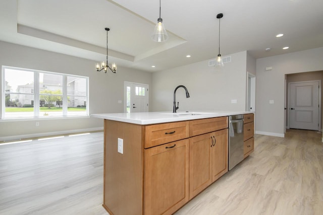 20840 Gray St, Lannon, WI 53046 - kitchen with stainless steel dishwasher, a sink, light wood finished floors, light countertops, and a chandelier