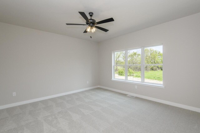 20840 Gray St, Lannon, WI 53046 - unfurnished room with baseboards, light colored carpet, and ceiling fan