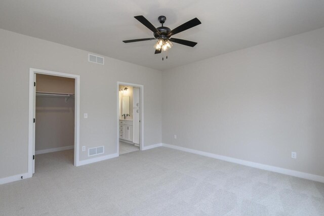 20840 Gray St, Lannon, WI 53046 - unfurnished bedroom featuring a spacious closet, light colored carpet, baseboards, a closet, and ensuite bath