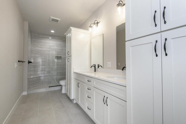 20840 Gray St, Lannon, WI 53046 - full bath with double vanity, toilet, a stall shower, tile patterned floors, and baseboards